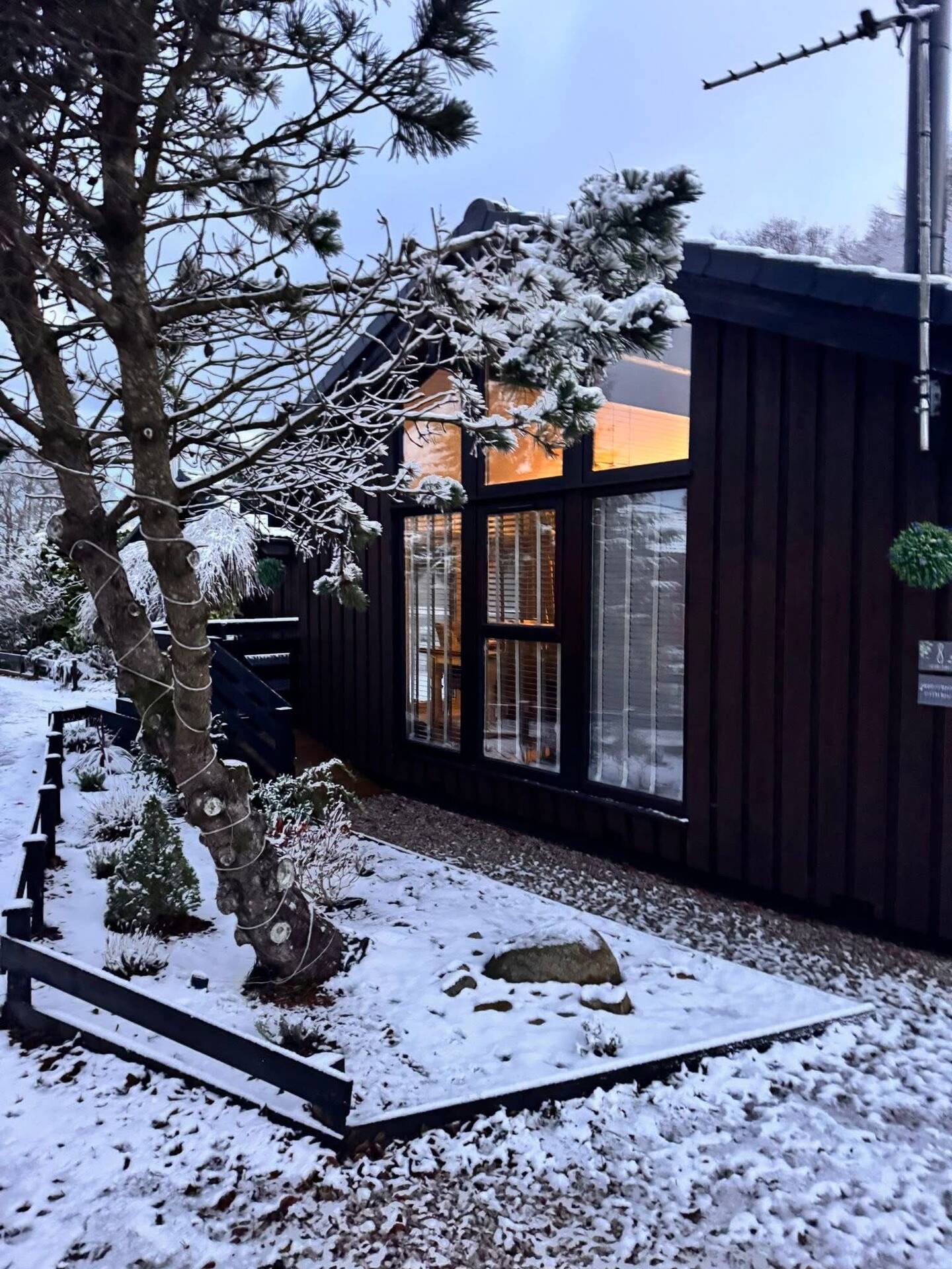 Fig Tree Lodge glowing warmly on a snowy winter evening